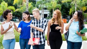 Group of students walking outdoor on campus of university