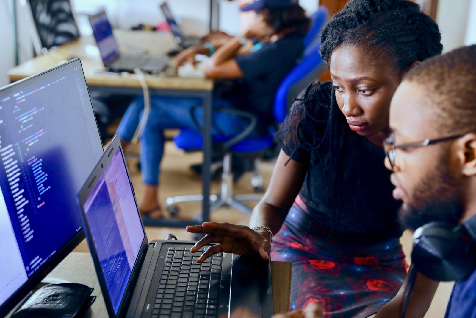 Woman helping Man at Computer