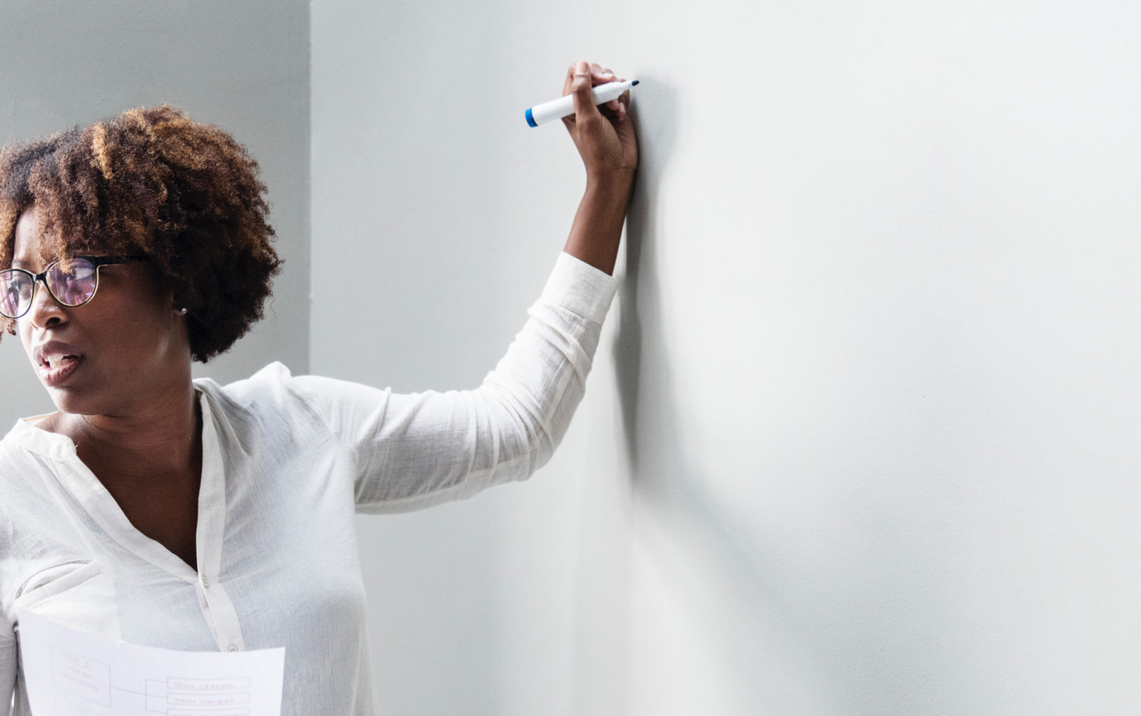 Teacher Writes on White Board