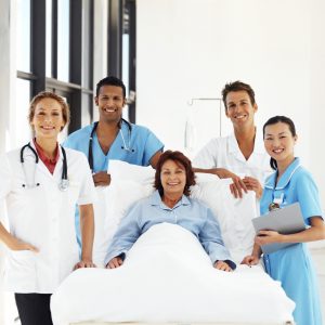 portrait of medical personnel standing around a patient's bed