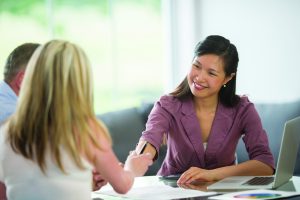 A husband and wife are seeking financial advice from a financial planners. They are discussing their retirement plan, loans, mortgages, 401K, and budget.