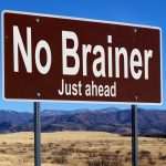 No Brainer brown road sign with blue sky and wilderness
