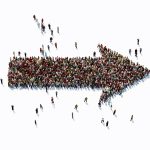 Human crowd forming an arrow symbol on white background. Horizontal composition with copy space. Clipping path is included. Social Media concept.